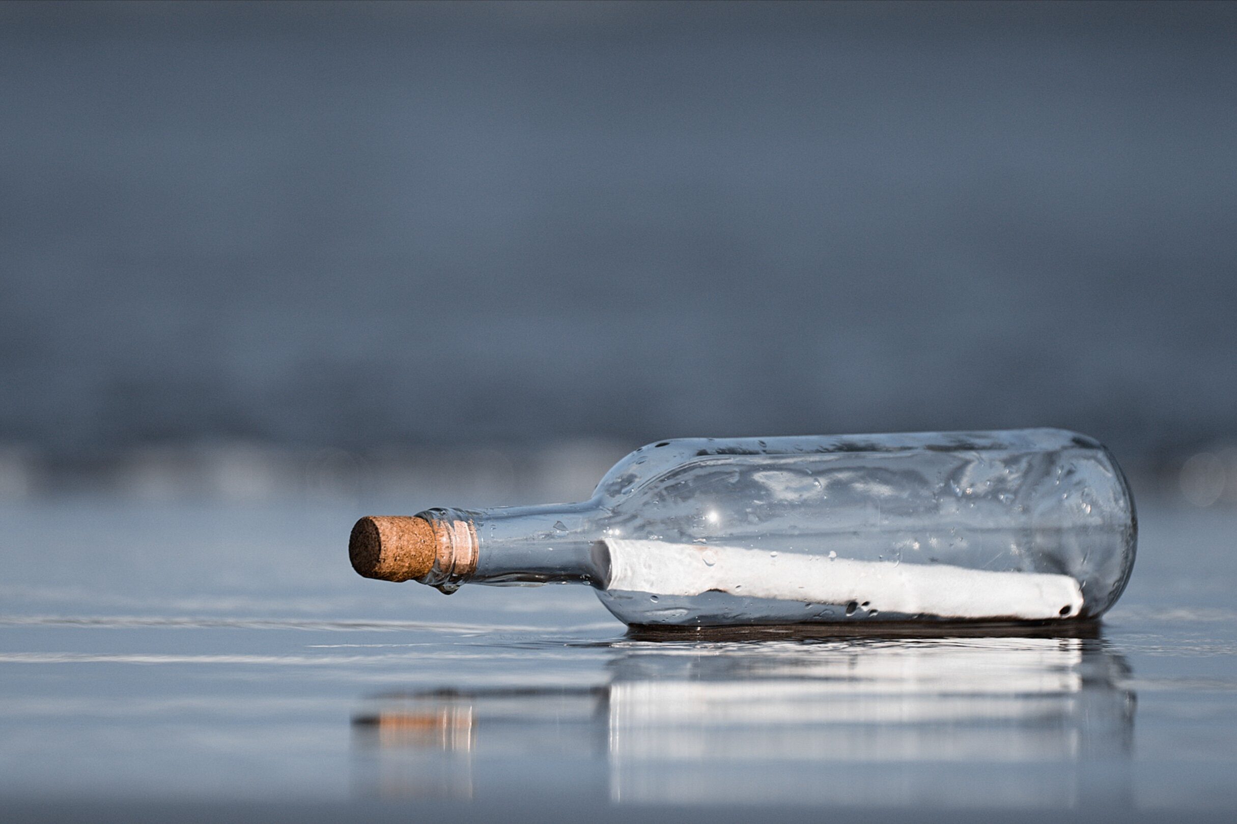 photo of a message in a bottle on the beach